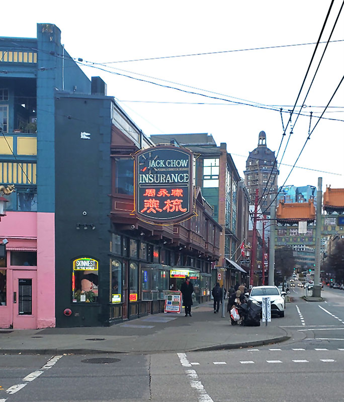 The Last Brothel in Vancouver's Chinatown 5 The iconic Sam Kee Building, known as the Skinniest Building in the World, in Vancouver's Chinatown, with WT Whiteway's Sun Tower visible in the background.