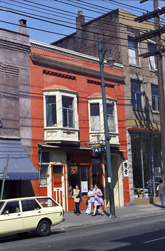 The Last Brothel in Vancouver's Chinatown 7 Historic image of 111 East Pender Street in the 1960s/70s, showing Tom's Taxi storefront and other businesses like the Green Door Restaurant and a gambling club.