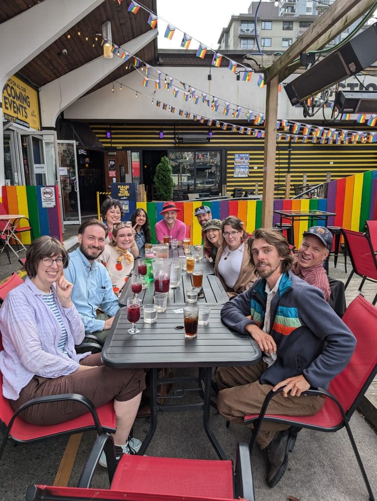 Pride Month team building Vancouver An image of a PRIDE team social enjoying post-tour drinks and appies on Davie Street at the Junction