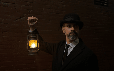 Halloween Vancouver 2026: storyteller holding a lantern on the Lost Souls of Gastown walking tour